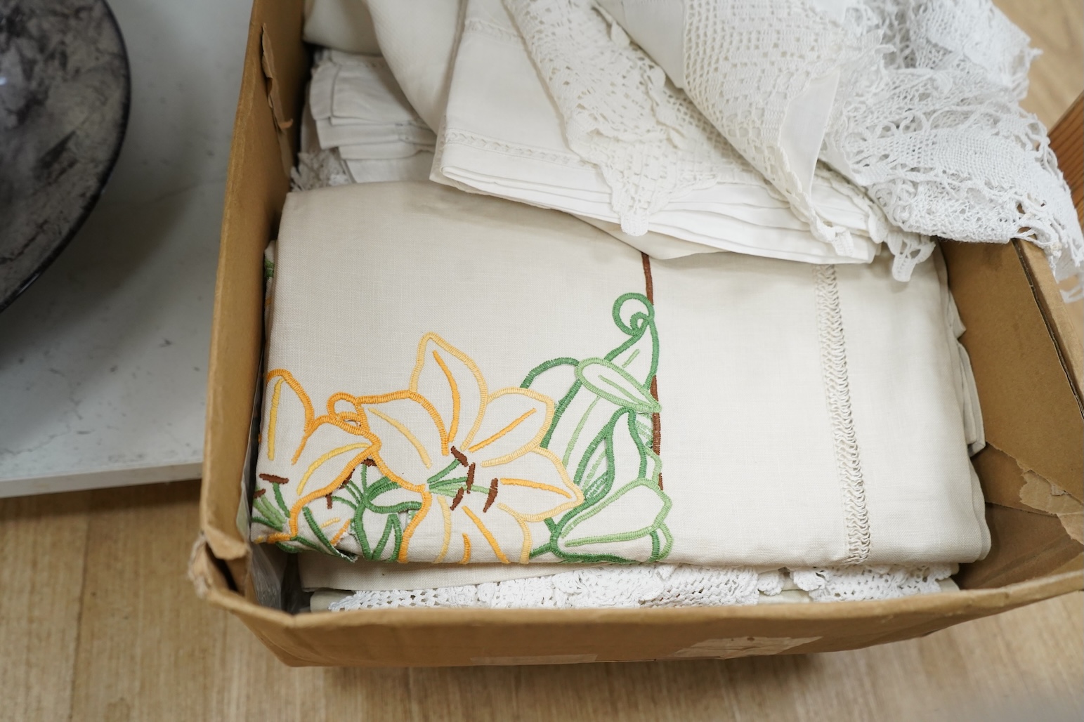 A collection of embroidered and crochet linen table cloths etc
